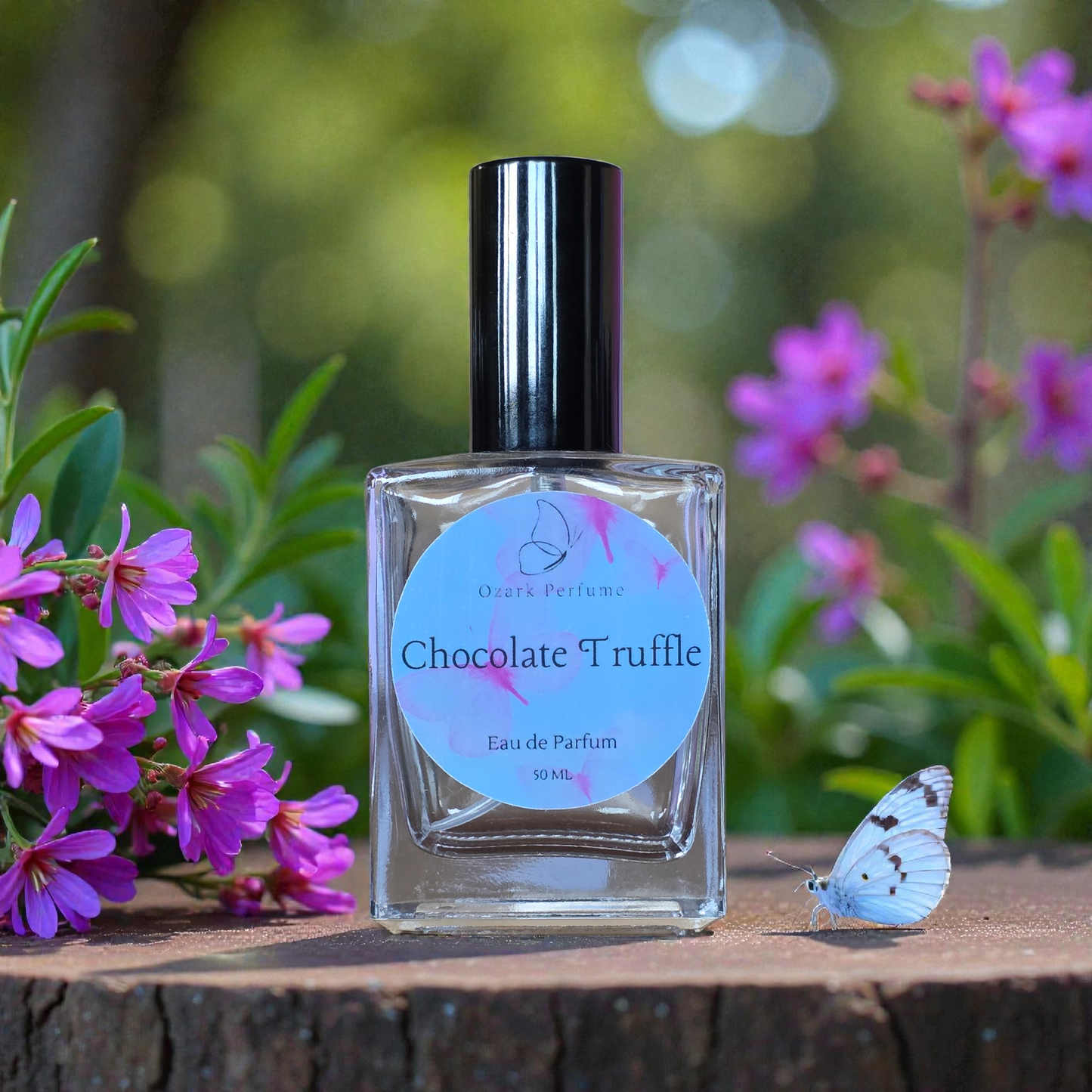 Bottle of 'Chocolate Truffle' perfume with a butterfly and flowers in the background