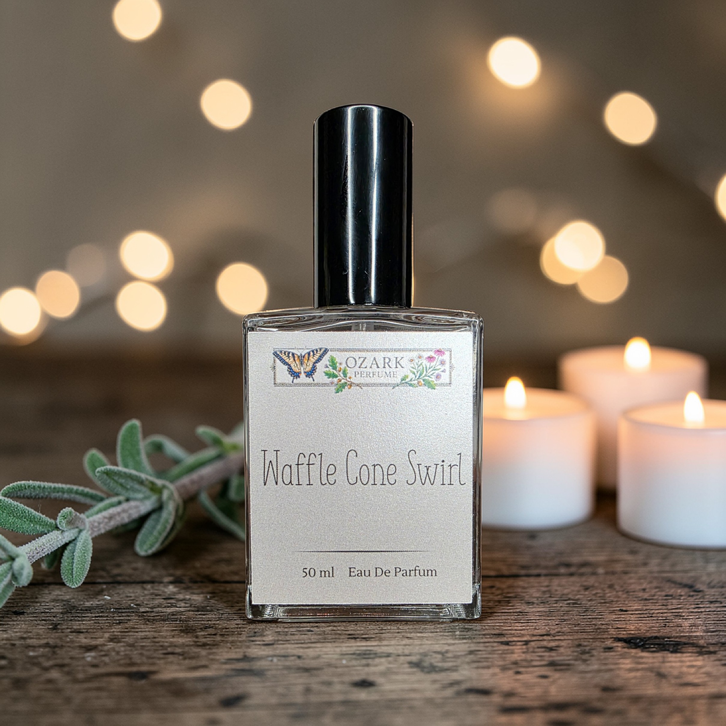 Perfume bottle labeled 'Waffle Cone Swirl' with a blurred background of lights and candles.