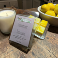 Ozark Trail Summer Lemons wax melts with a candle and lemons on a wooden surface