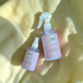 bottle with pale pink label names sunshine on a pastel yellow blanket