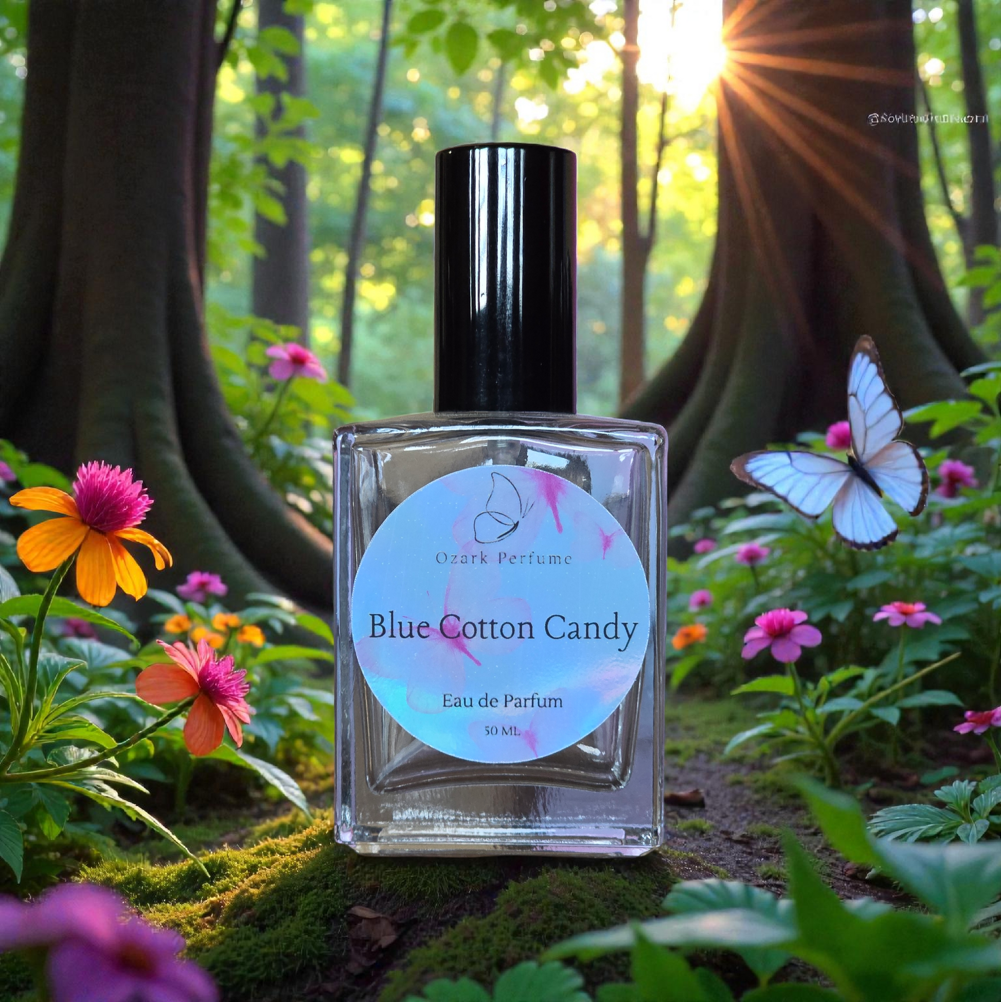 Perfume bottle labeled 'Blue Cotton Candy' in a forest setting with flowers and a butterfly.