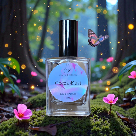 Perfume bottle labeled 'Cocoa Dust' with a butterfly and flowers in a mystical forest setting