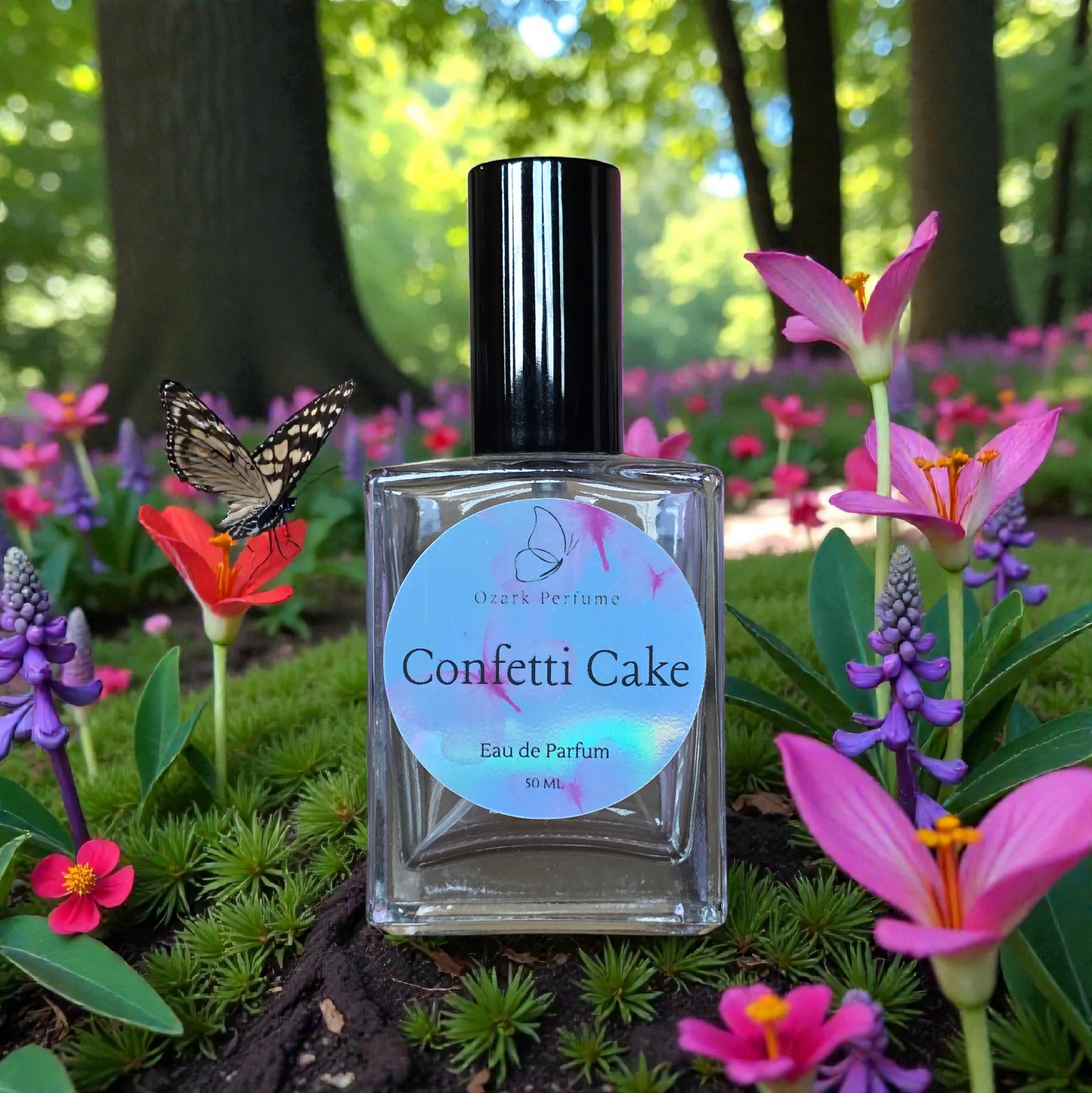 Perfume bottle labeled 'Confetti Cake' surrounded by flowers and a butterfly in a forest setting