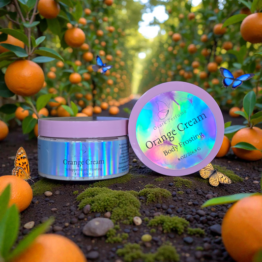 Orange Cream body frosting jar with a colorful label in an orange orchard.