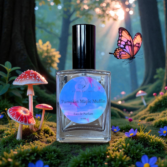 Eau de Parfum bottle labeled 'Pumpkin Maple Muffin' with a fantasy forest background featuring mushrooms and a butterfly.