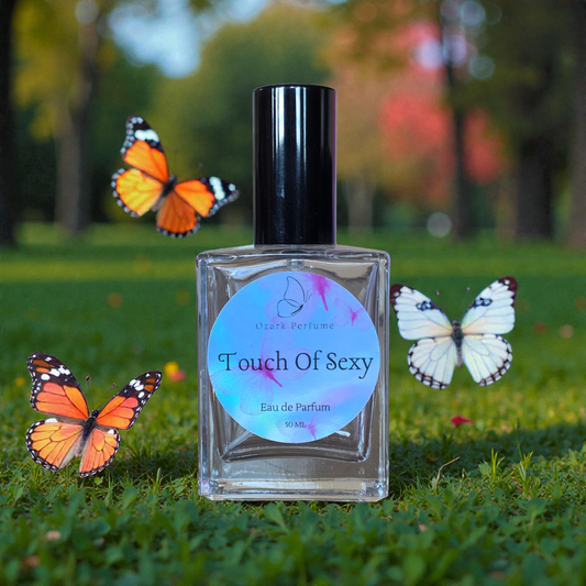 Perfume bottle labeled 'Touch Of Sexy' with butterflies on a grassy background